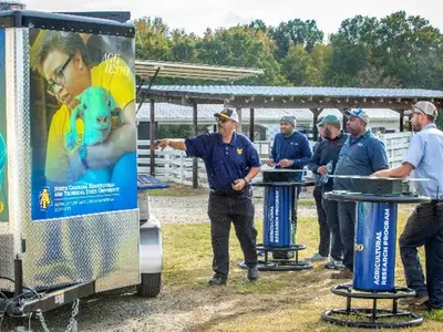 NC A&T’s Gregory Goines giving a presentation to farmers on solar-powered charging trailers