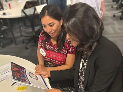 Guatemala women looking at brochure