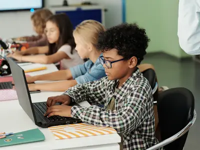 Students filling out information on a computer