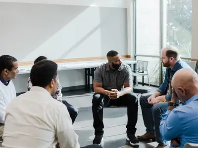 Group of men discuss challenging issues