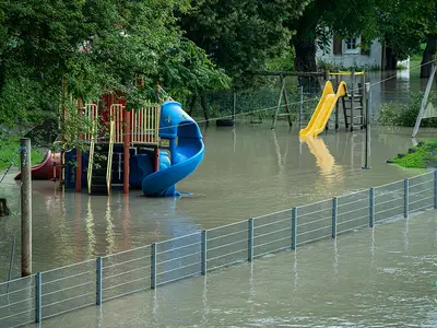A playground surrounded by floodwaters