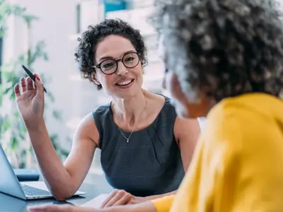 Consultant talks to client in office