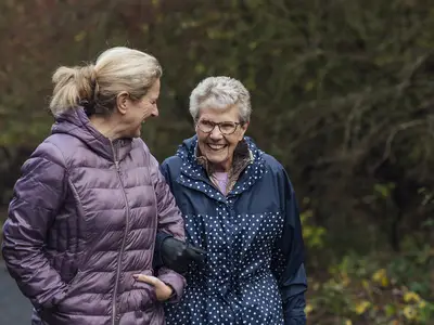 Woman walking with her elderly mom