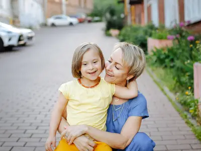 Mother embraces daughter