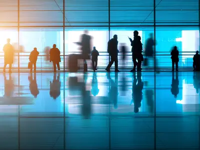 Abstract photo of people walking in an office