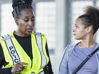 Female police officer talking to a woman