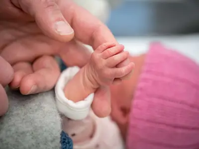 Holding newborn baby's hand