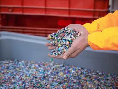 Hands holding small pieces of plastic