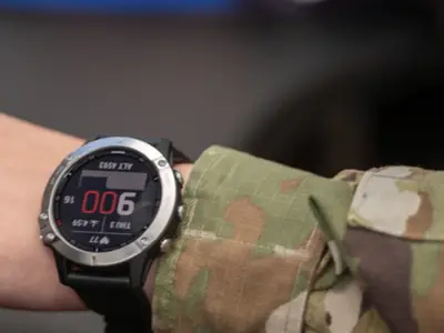 Close-up of wrist of military personnel wearing health-tracking watch