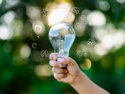 Hand holding lightbulb 