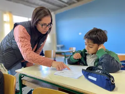 Teachers helps young student