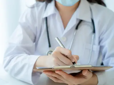 Stock photo of doctor holding clipboard