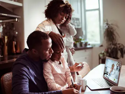 Family consults with doctor via teleheatlh
