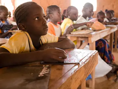 An elementary-age girl attends a reading class in Senegal.