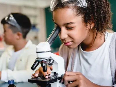 female student looking into telescope