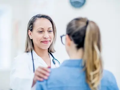 Doctor comforting an adult patient