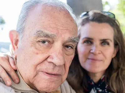 A senior man and his adult daughter.