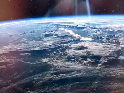 A satellite view of the earth with scattered clouds. 