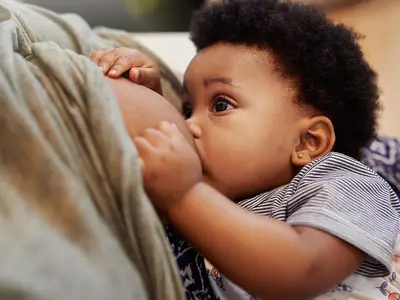 A mother breastfeeds her baby.