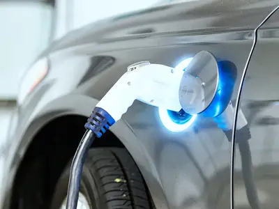 An electric car is plugged into a charger.