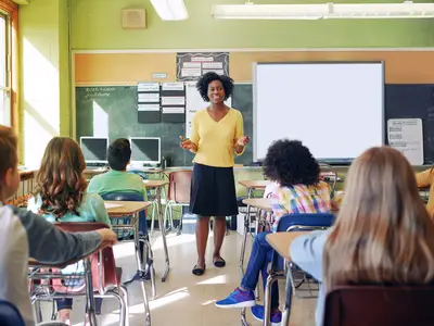 Teacher educating a group of children