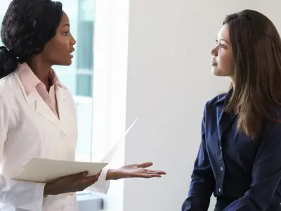 Woman speaking with doctor