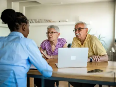 Senior couple sitting with an advisor