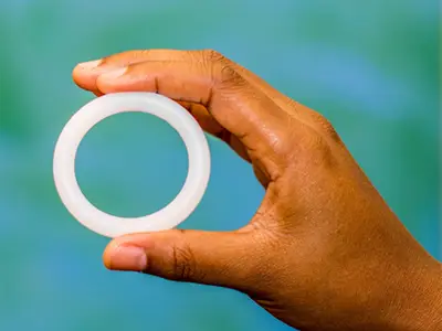 A hand holding a vaginal ring, which can be used to deliver contraceptives, HIV preventatives, and other drugs.