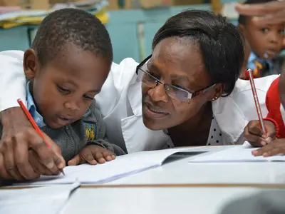 A teacher works with a child in the Tayari early education program in Kenya.