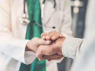 Doctor comforts patient in a clinical setting