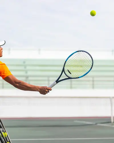 Man in wheelchair playing tennis