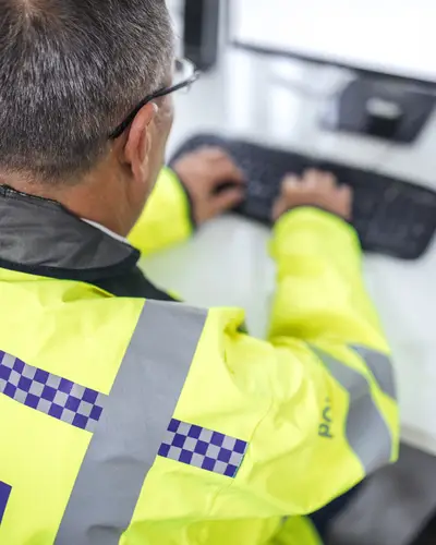 A police officer typing
