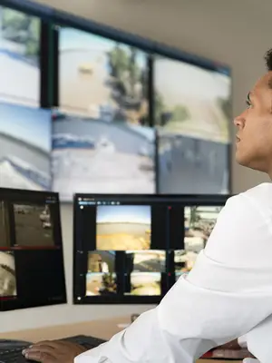 employee checking security footage on monitors