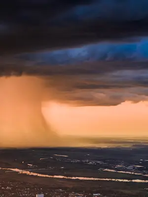 Large rain cloud over a town. Aerial drone footage. 