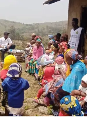 Photo of antenatal clinic in Cameroon with mothers and children and care workers.