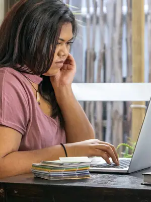 Photo of student working on a laptop.