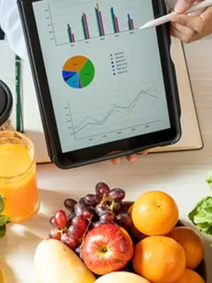 Nutrition graphs on an iPad with various healthy foods in the background