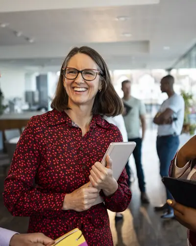 Team smiling and conversing in a workspace