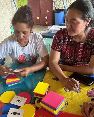 Photo of two teachers working together in a workshop.