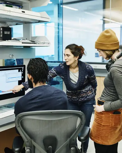 Photo of three scientists looking at data.