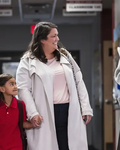 A teacher talking to a student and her mom and dad