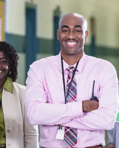 A group of teachers standing together smiling 