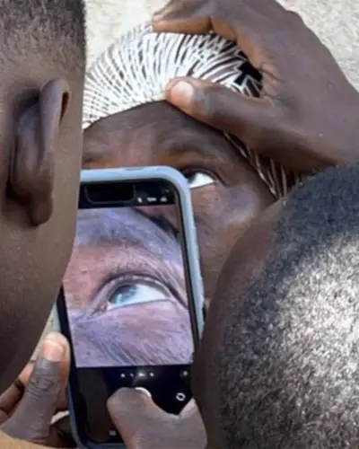 Person scanning another person's eye with phone