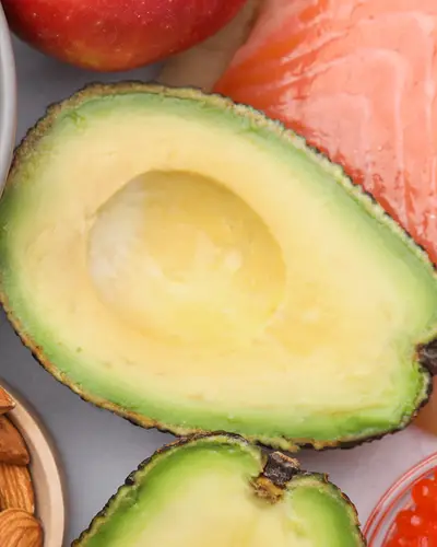 Blueberries, almonds, kiwi slice, avocado halves, salmon