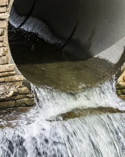 Storm drain with water flowing through it