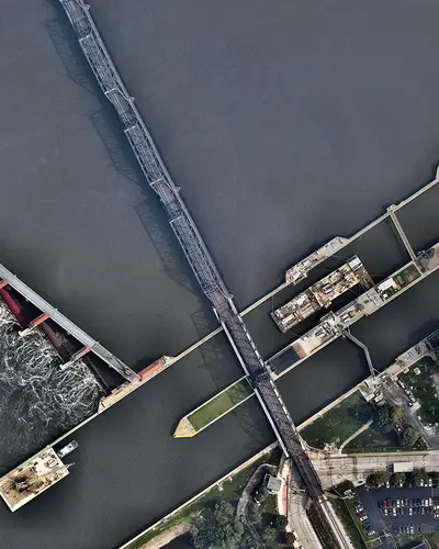 Aerial view of river with dam and water plant