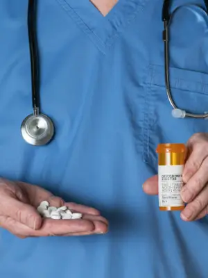 Doctor holding pills