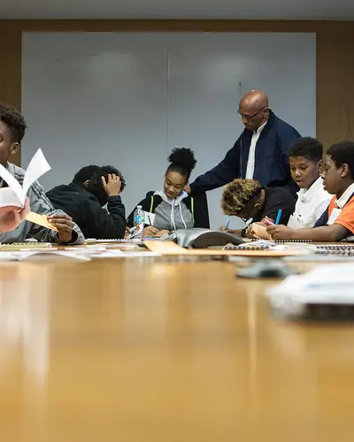 Students sit at a table for a discussion