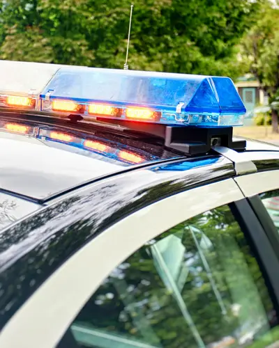 Police cars on a city street in the daytime