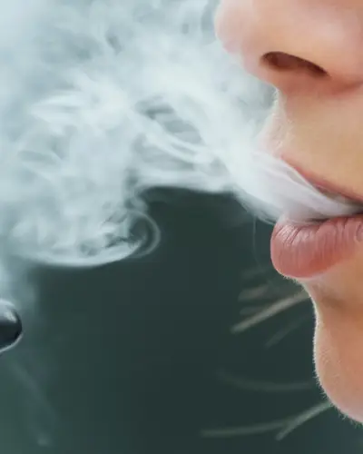 Closeup of a young woman using an electronic cigarette